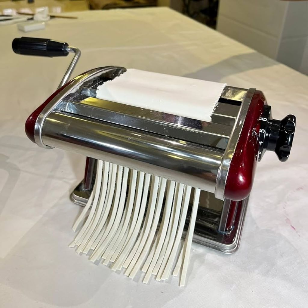 Close-up of LEONEBEBE pasta machine in use for homemade pasta.