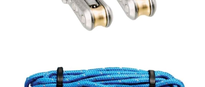 Person using a rope cinching tool to secure camping gear, showing practical application.
